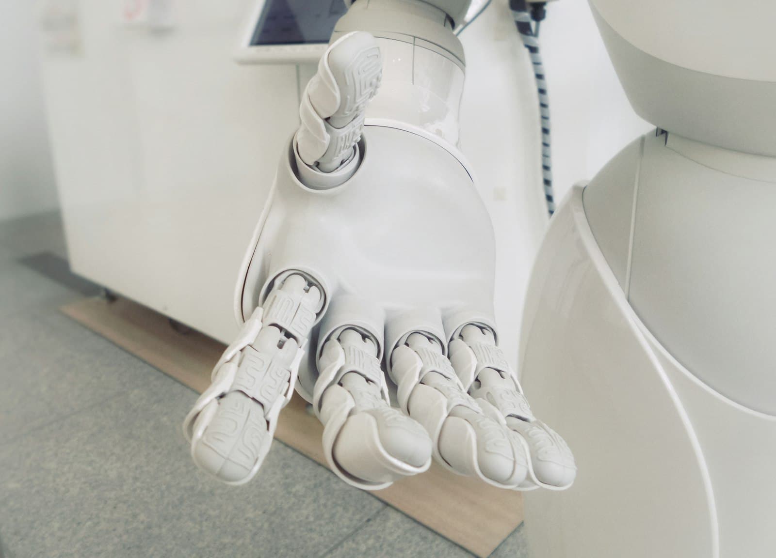Close-up of a white robotic arm extending its palm